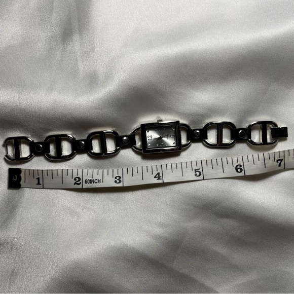 Silver tone buckle watch with black leather style grommets - Picture 4 of 4